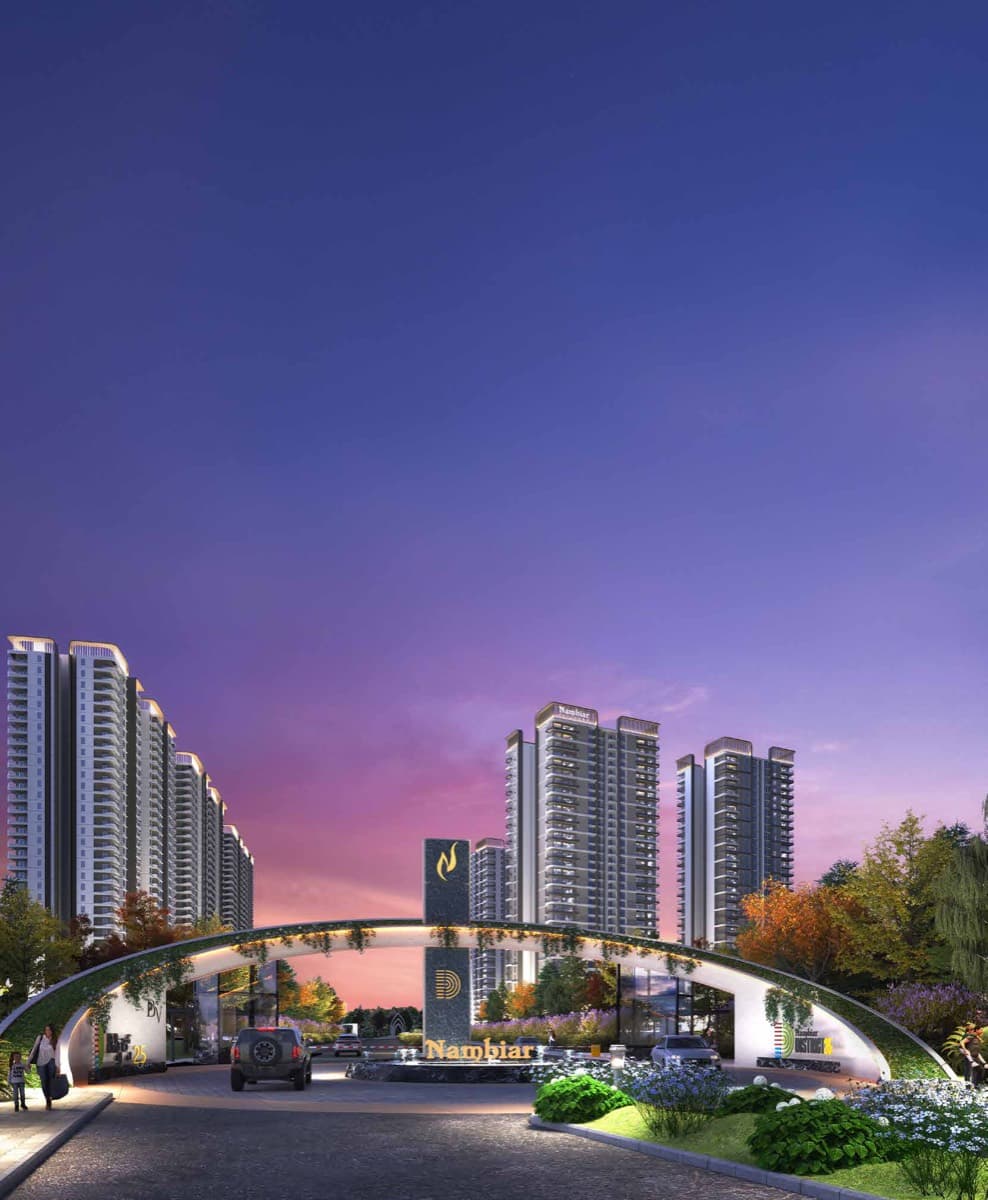 The arched township entrance lit violet at dusk
